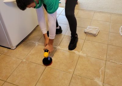 chem-dry technician scrubbing tile floors